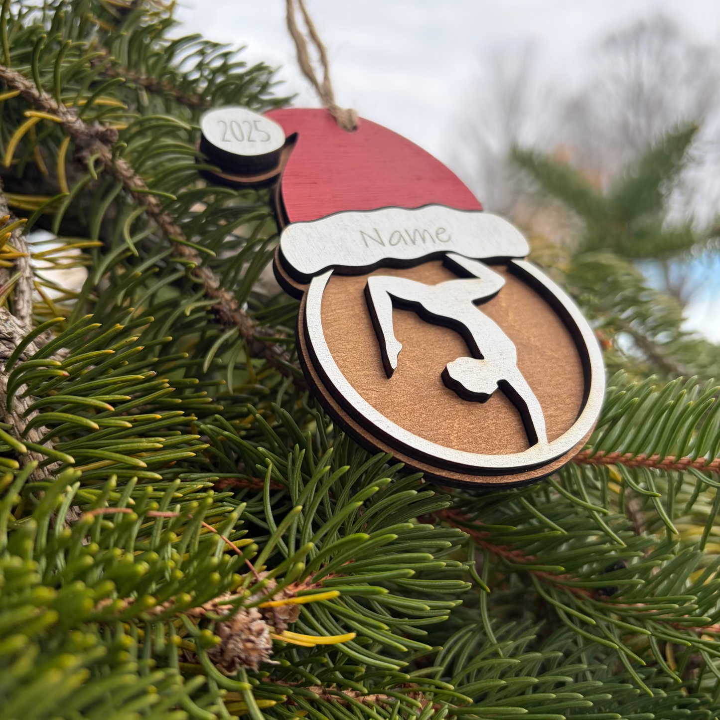 Personalized wooden Christmas ornament for gymnast with a Santa hat.