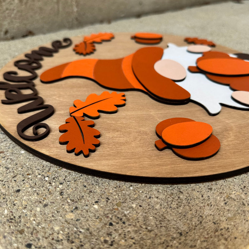 Wooden sign with a gnome and leaf design