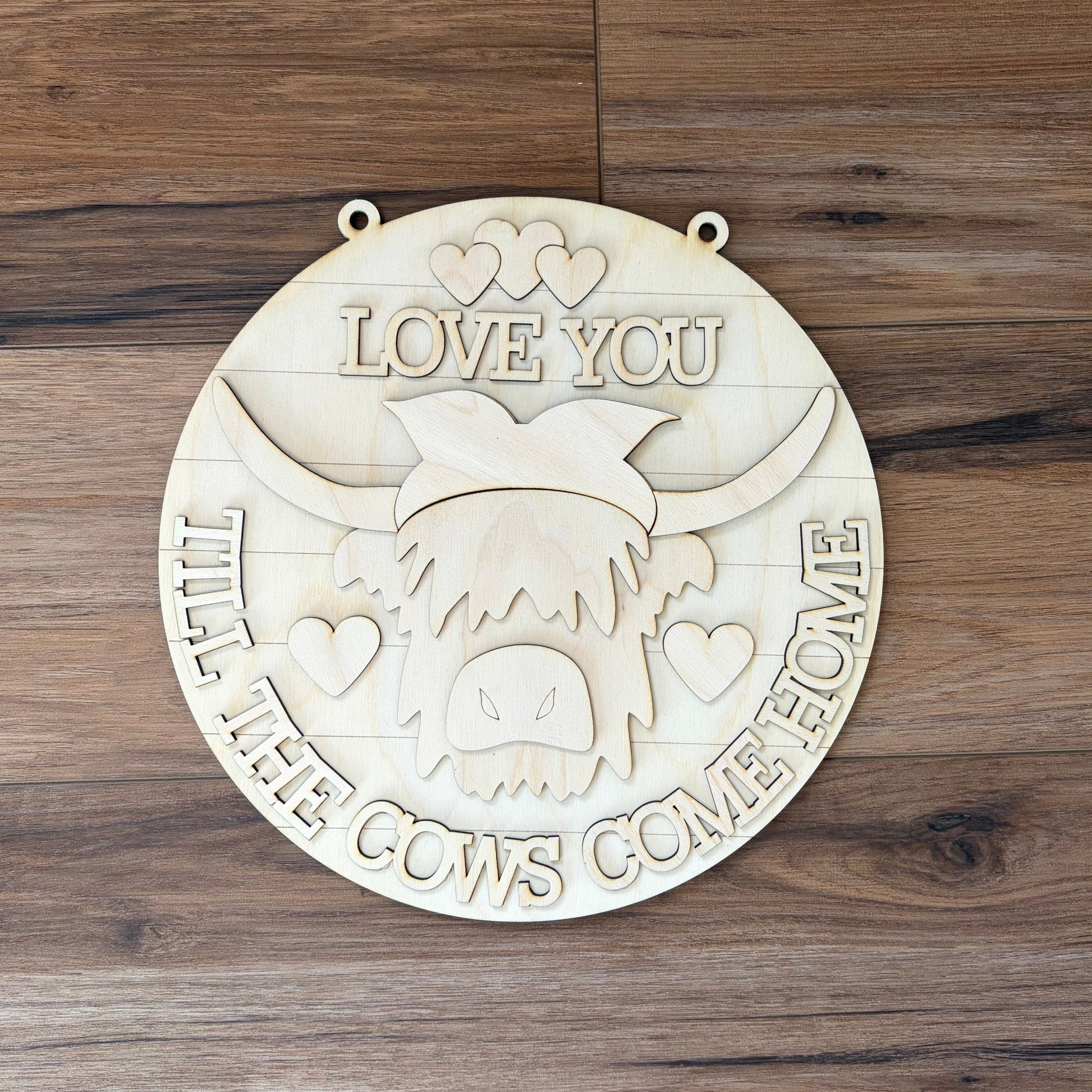 Unpainted wood sign for DIY kit with a highland cow wearing a bow saying "love you til the cows come home"