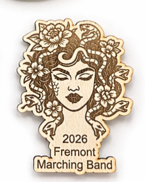 Wooden magnet with a design of a woman's face surrounded by flowers and leaves, with '2026 Fremont Marching Band' text.