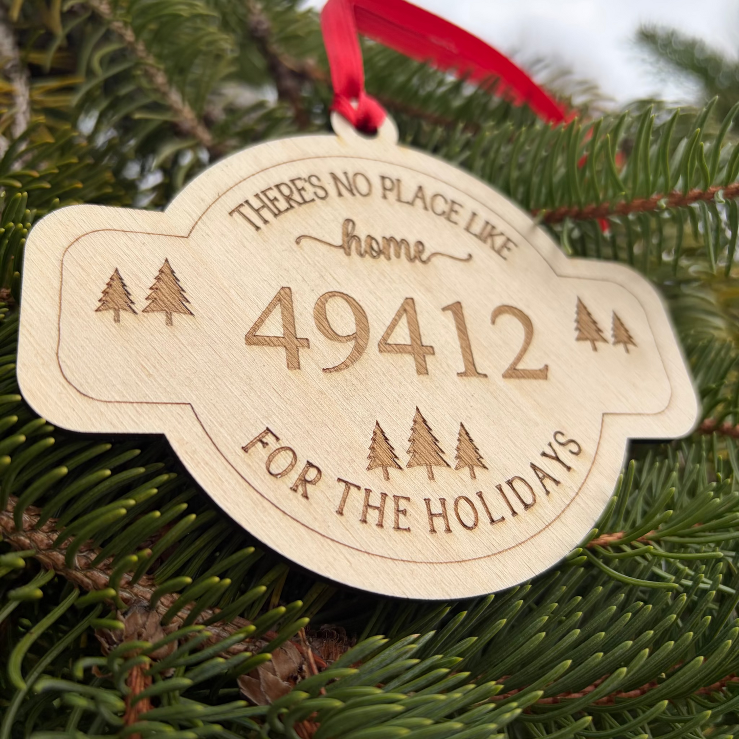 Wooden ornament with engraved text on a Christmas tree