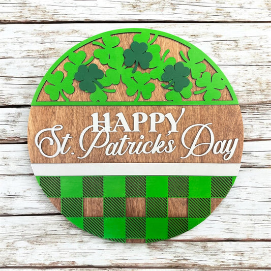 Round wooden sign with green shamrocks and plaid pattern, featuring 'Happy St. Patrick's Day' text on a wooden background.