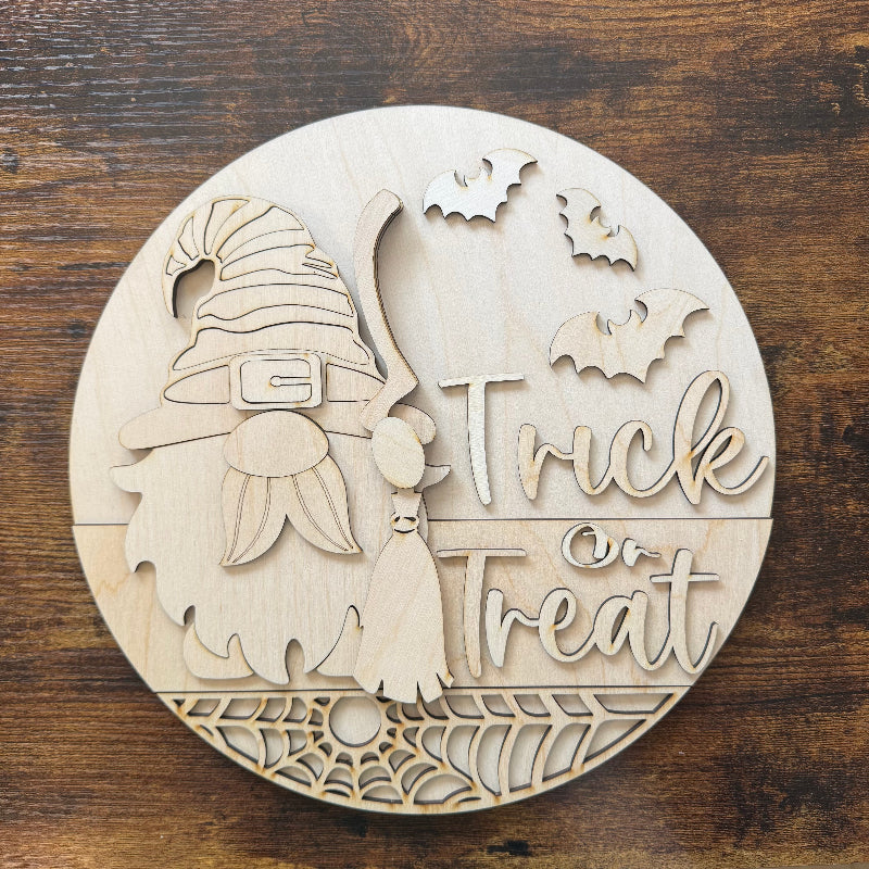 Wooden Halloween decoration with gnomes and 'Trick or Treat' text on a wooden background
