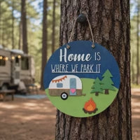 12 inch round 3D wood sign with a retro camper in a campground